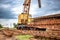 A yellow crane is positioned atop a train track, ready for maintenance or construction work