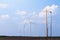 Yellow crane tower placing windmill blade with background of blue sky. Wind Turbine Construction