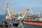 Yellow cranes and container ship in Odessa sea port,Ukraine