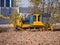Yellow crawler bulldozer with blade and plow working at a construction site. Site preparation for the construction of