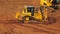 Yellow crawler bulldozer mining sand at quarry. Heavy machinery mining