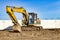Yellow crawler excavator at the construction site. Earthworks at a construction site. Modern earthmoving equipment