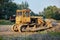 Yellow crawler tractor in gravel canyon