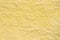 Yellow creased pastel paper background texture