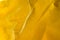 Yellow creased tissue paper background texture selective focus