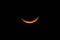 Yellow crescent moon in a starless sky