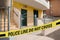 Yellow crime scene tape blocking way to house outdoors