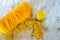 Yellow crochet yarn with candle on neutral background