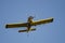 Yellow Crop Dusting Plane Flying in a Blue Sky