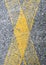Yellow cross on asphalt
