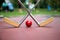Yellow crossed iron rackets and a red ball at a minigolf court a
