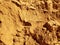 Yellow crumbly sand. Dry soil texture and background. The background of the red soil. Abstract land. Natural abstraction. Clay.