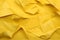 Yellow crumpled paper texture abstract background