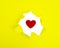 Yellow crushed torn paper with red heart hole copyspace background for idea
