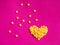 Yellow crystal craft handmade heart shape for diamond embroidery hobby rhinestone. Background with bright leather texture. Pink