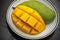 Yellow cubes sliced mango on plate