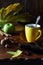 Yellow cup of coffee, nuts, autumn leaves and green apple