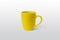 Yellow cup on gray surface for logo branding mockup