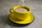 Yellow cup  vintage   caffeine  beverage  cappuccino on concrete background