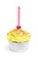 Yellow cupcake with candle over white