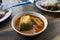 Yellow curry fish in bowl white thai southern style food, khaw khang-ti Thai word, Large pieces of fish soup in a cup is Thai As