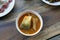 Yellow curry fish in bowl white thai southern style food, khaw khang-ti Thai word, Large pieces of fish soup in a cup is Thai As