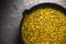 Yellow curry paste in a cast-iron frying pan closeup. Indian food