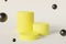 Yellow cylinder stand or pedestal for products with soaring spheres.