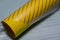 Yellow cylinder and translucent striped material
