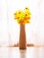 Yellow daffodil on a light color background. Traditional simple flowers for house decoration