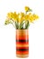 Yellow daffodils and freesias flowers in a vivid colored vase, close up, isolated, white background