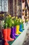 Yellow daffodils and hyacinth in multicolored rubber boots used as pots decorating the storefront window. Selective focus