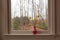 Yellow daffodils in a pink vase on a white windowsill on a gray afternoon.