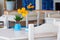 Yellow daisy flowers in blue vase on a table at Greek tavern on Crete island