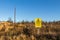 Yellow danger sign warning of overhead electrical power lines and risk of death