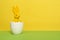 Yellow decoration easter bunny in a white egg on a yellow and green background with copy space