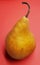 Yellow delicious pear over red background. Healthy pears.