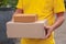 Yellow delivery man carry parcels