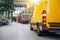 Yellow delivery van on a street inside a city