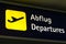 Yellow departures sign in German and English
