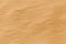 Yellow desert sand texture with wave patern.