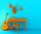 Yellow desk and chair on blue background. Composition with table, guitar, ball, decorative deer head and baseball cap.
