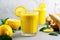 yellow detox smoothie with a lemon slice by the side