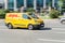 Yellow DHL delivery van speeding through the city. Van delivering posts and parcels. DHL is a world wide courier company