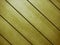 Yellow diagonal interior design wooden slat wall wood panel designer decor closeup painted background