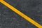 Yellow diagonal marking line on the asphalt road