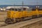 Yellow diesel locomotive freight train in sidings.