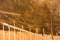 Yellow dilapidated wall with worn out barbed wire and old fence