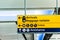 Yellow directional sign at the airport