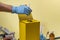 Yellow disposal box for contaminated or infectious products in a hospital or home